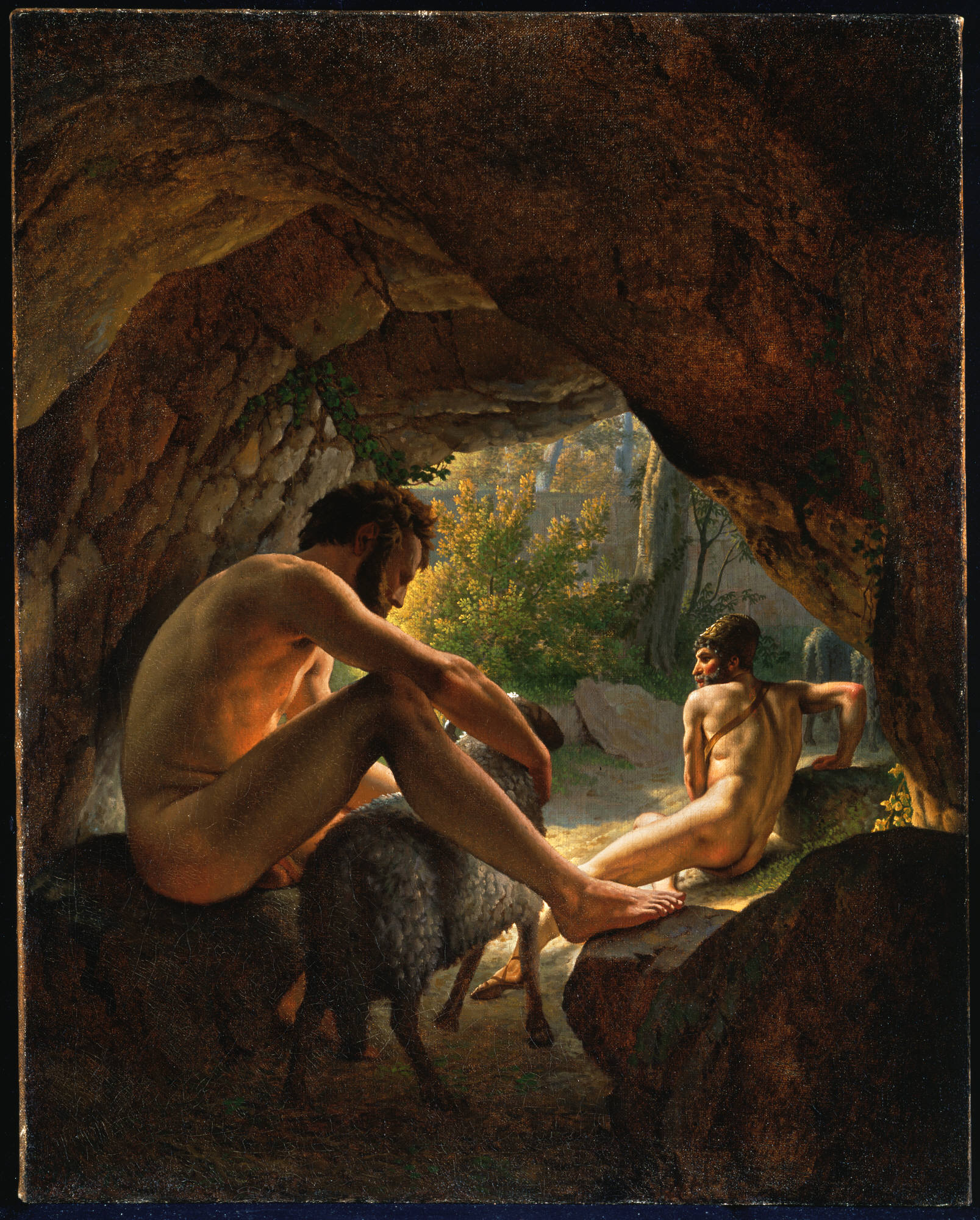 A dim rock cave opening onto a sunlit autumn wood. Two nude, bearded men creep out beneath the bellies of Polyphemus's heavy-fleeced rams: one at left, half in shadow, clings low against a dark ram's underside with his legs drawn up, watching warily; a second, already at the bright mouth of the cave at right, twists his head back over his shoulder as he clears the entrance. The blinded giant is not shown — only his flock and the escaping men — so the whole picture is the ram-escape held at the knife-edge instant before the open air, tense and hushed in Eckersberg's cool Neoclassical light.