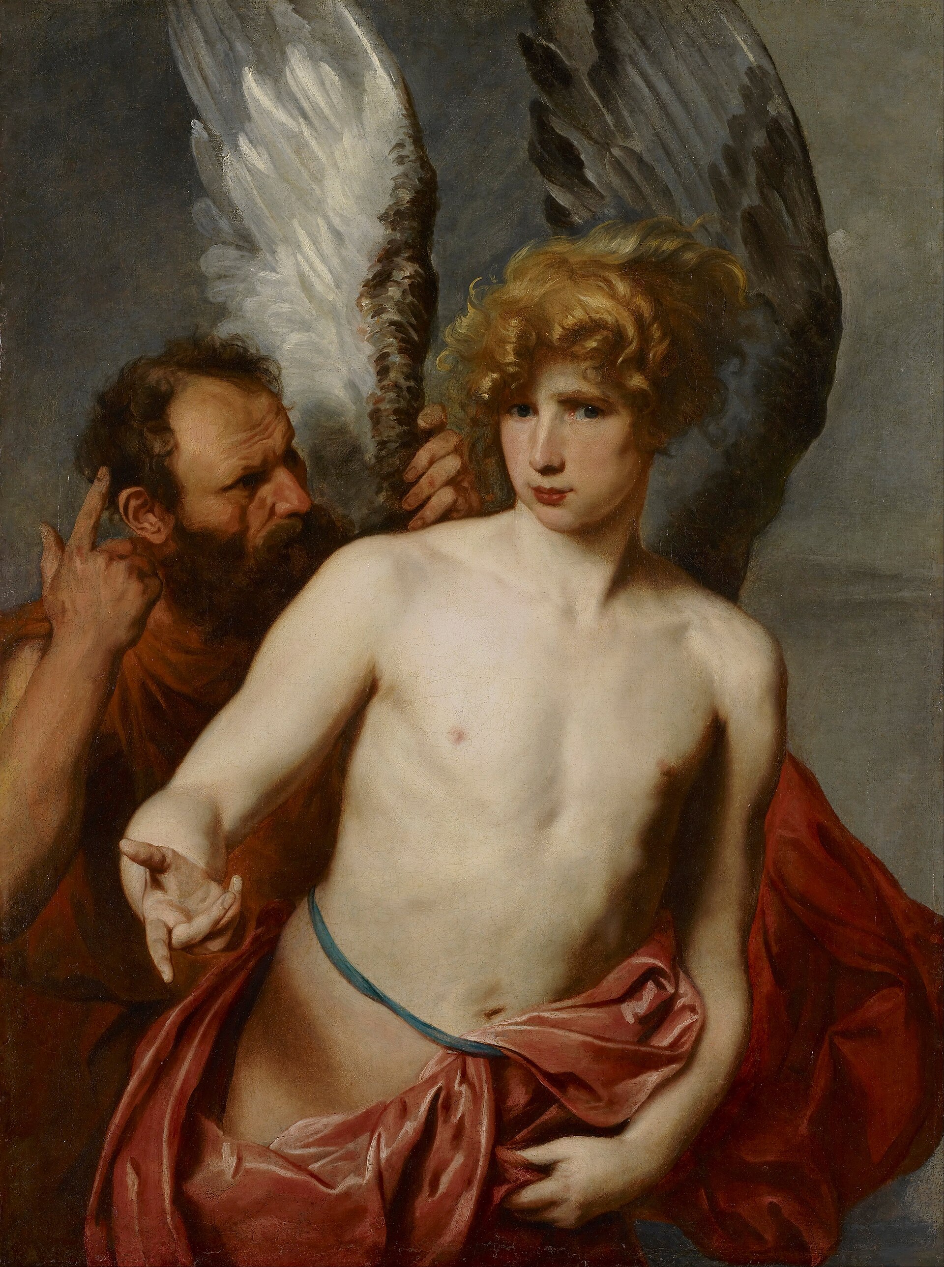 A Baroque painting of Daedalus and Icarus. The aged, balding, grey-bearded Daedalus stands behind his son in a russet-orange robe, one hand steadying a great feathered wing (one pinion pale, one dark) at the boy's shoulder while the other hand rises with a raised, admonishing finger, as though giving a warning. In front of him the youthful, bare-torsoed Icarus, with tousled golden hair and a red drape falling from his hips, gazes out past the viewer, one arm extended. The background is a plain, shadowed studio wall.