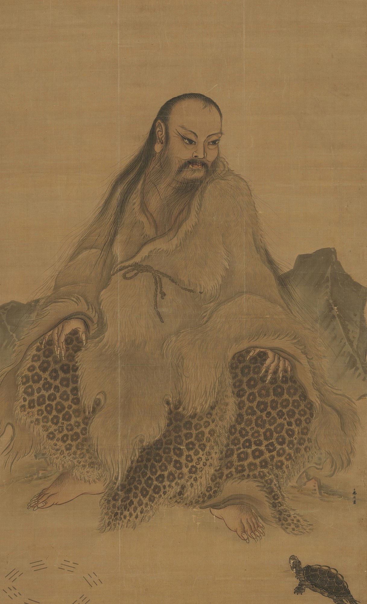 A seated portrait of Fuxi as the first sovereign — a long-haired, bearded sage in a fur-and-leopard-skin robe, hands resting on his knees on a rocky ground; the eight three-line trigrams (bagua) are drawn at the lower left and a turtle sits at the lower right.